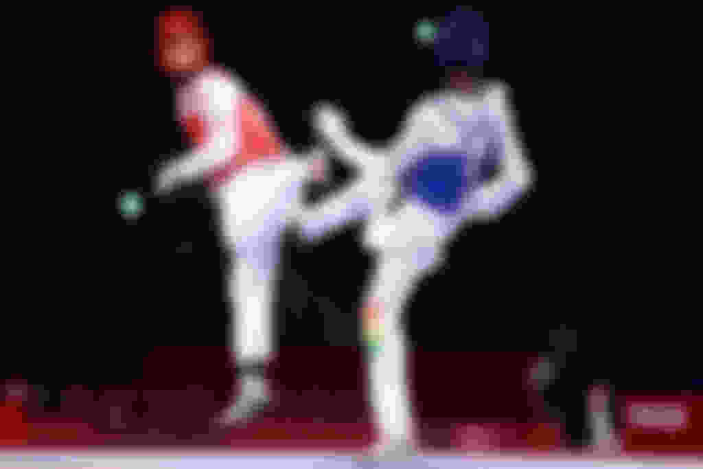 Ulugbek Rashitov (L) of Team Uzbekistan competes against Seydou Fofana (R) of Team Mali during the men's -68kg Taekwondo Qualification contest on day two of the Tokyo 2020 Olympic Games at Makuhari Messe Hall