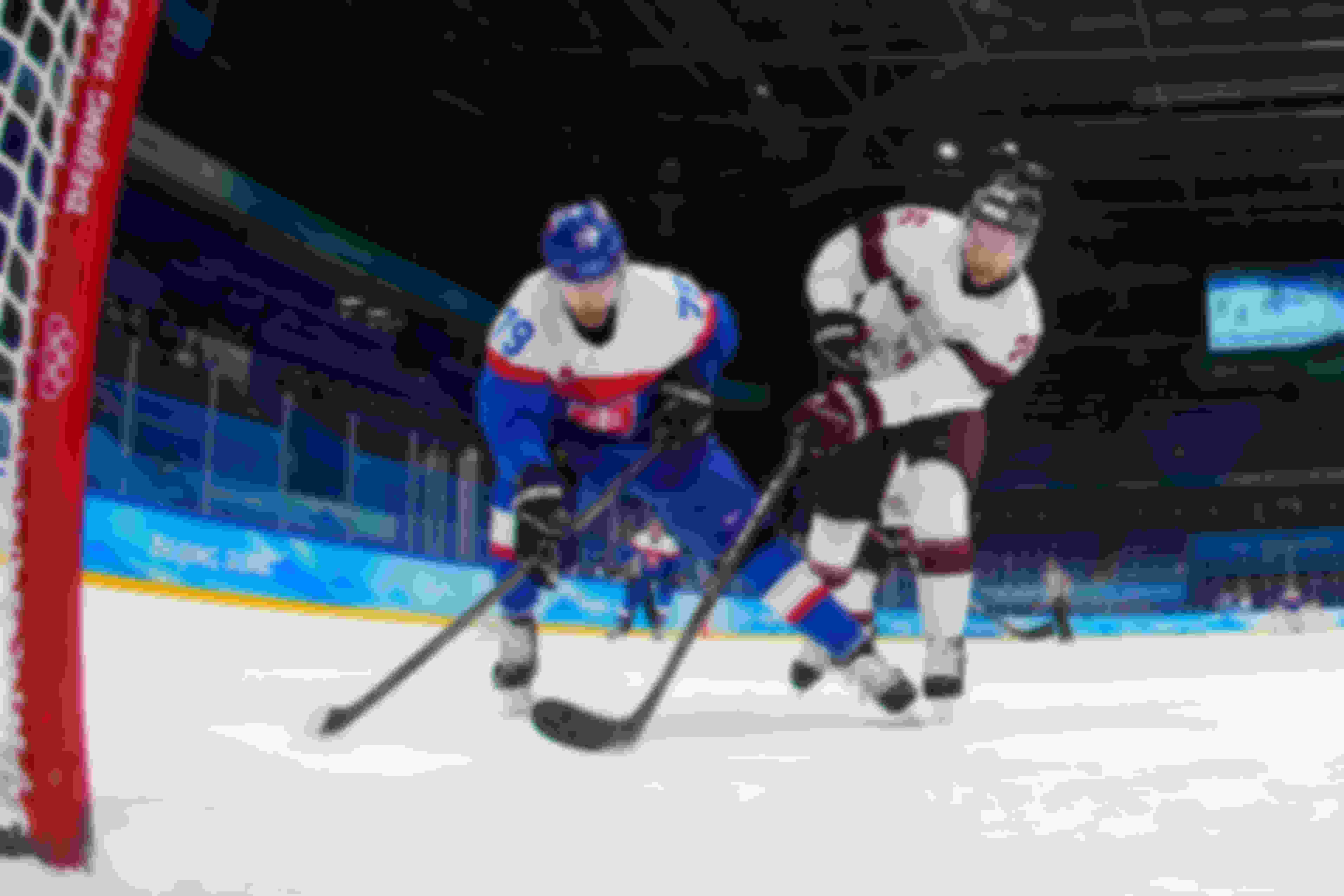 Libor Hudacek #79 of Team Slovakia and Uvis Balinskis #26 of Team Latvia skate in front of the net in the third period