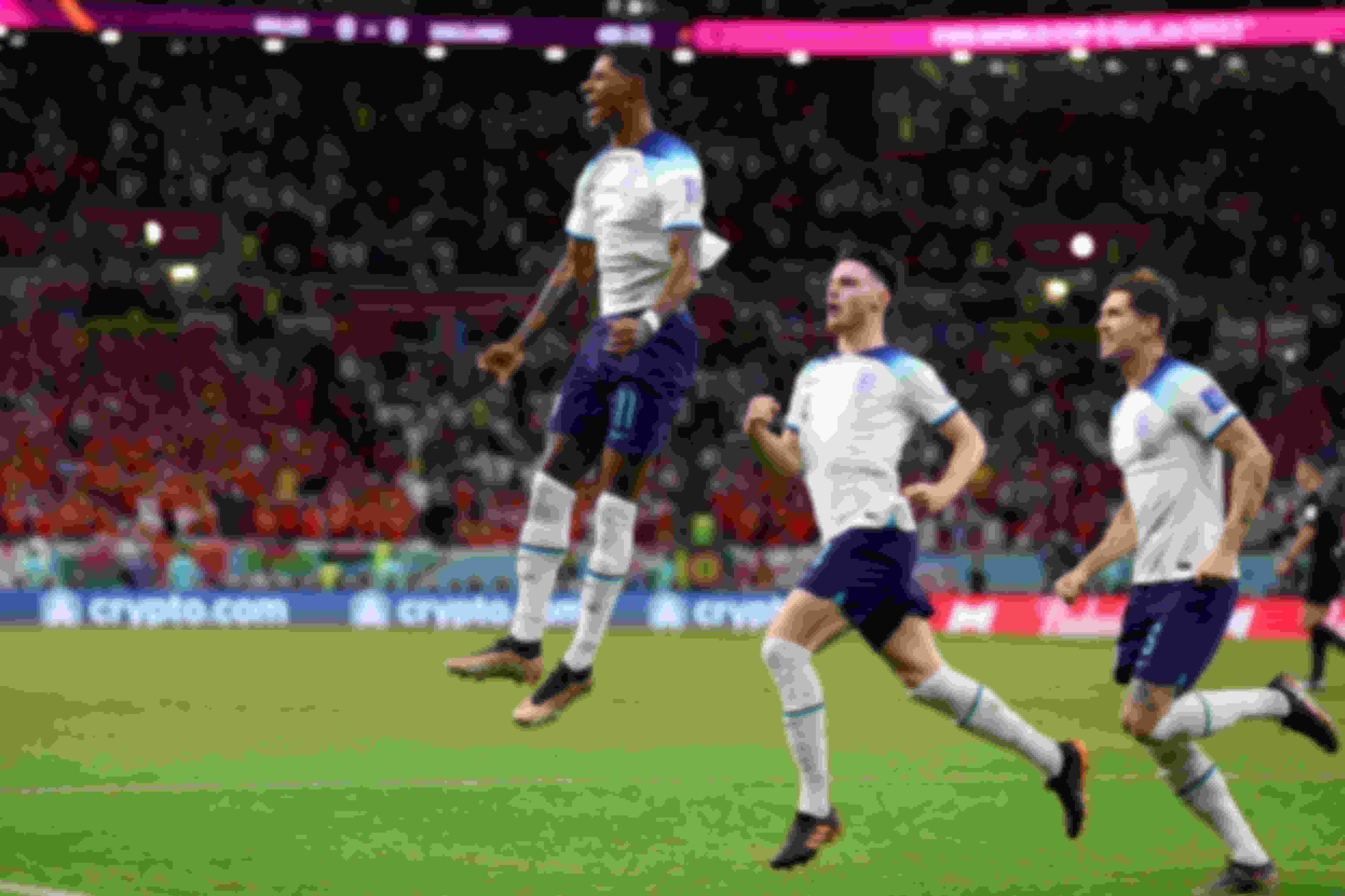 Marcus Rashford celebrates after scoring England's first goal during their Group B match against Wales