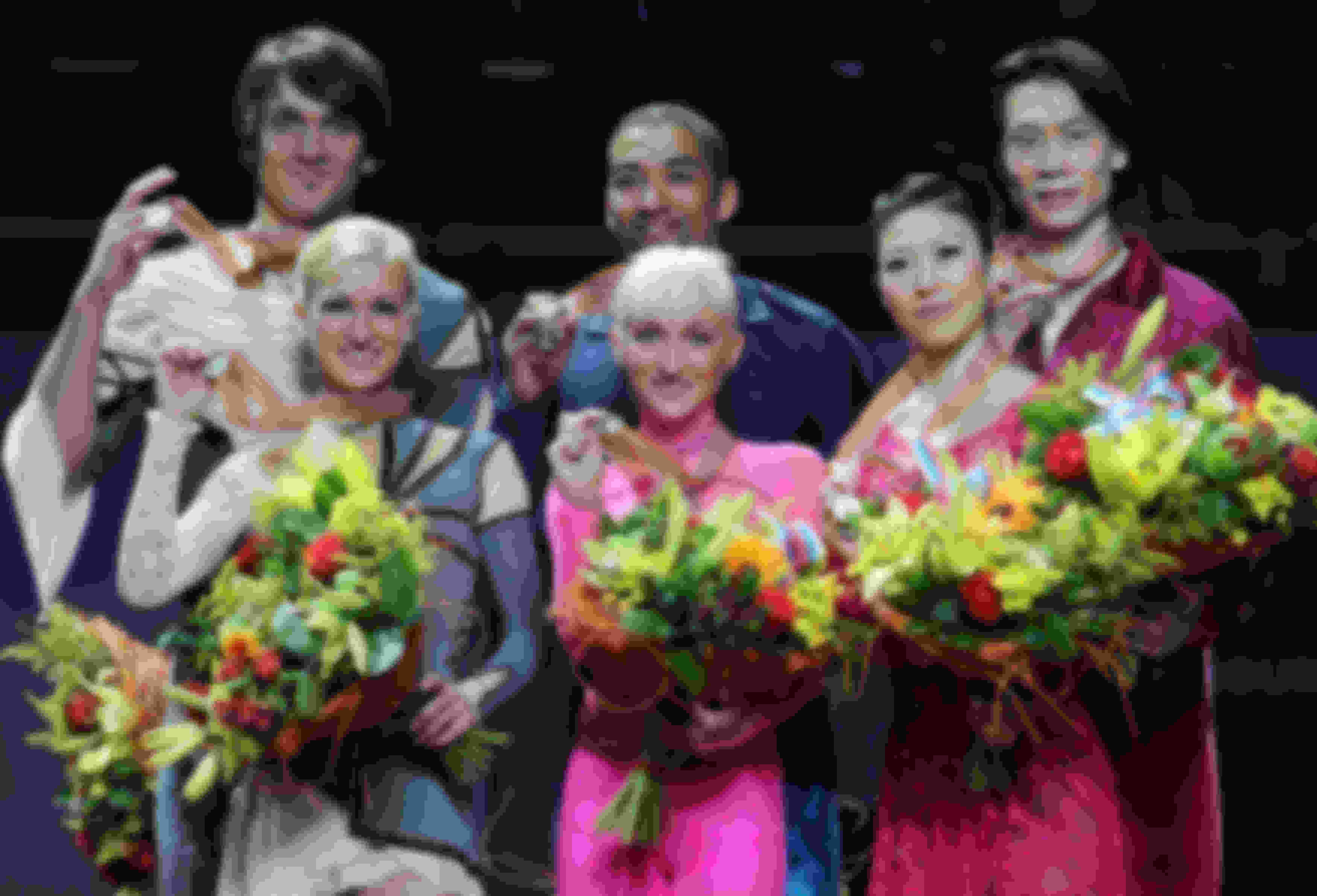 Aliona Savchenko and Robin Szolkowy (C), Tatiana Volosozhar and Maxim Trankov (L) and Pang Qing and Tong Jian stand on the podium at the World Championships in 2011