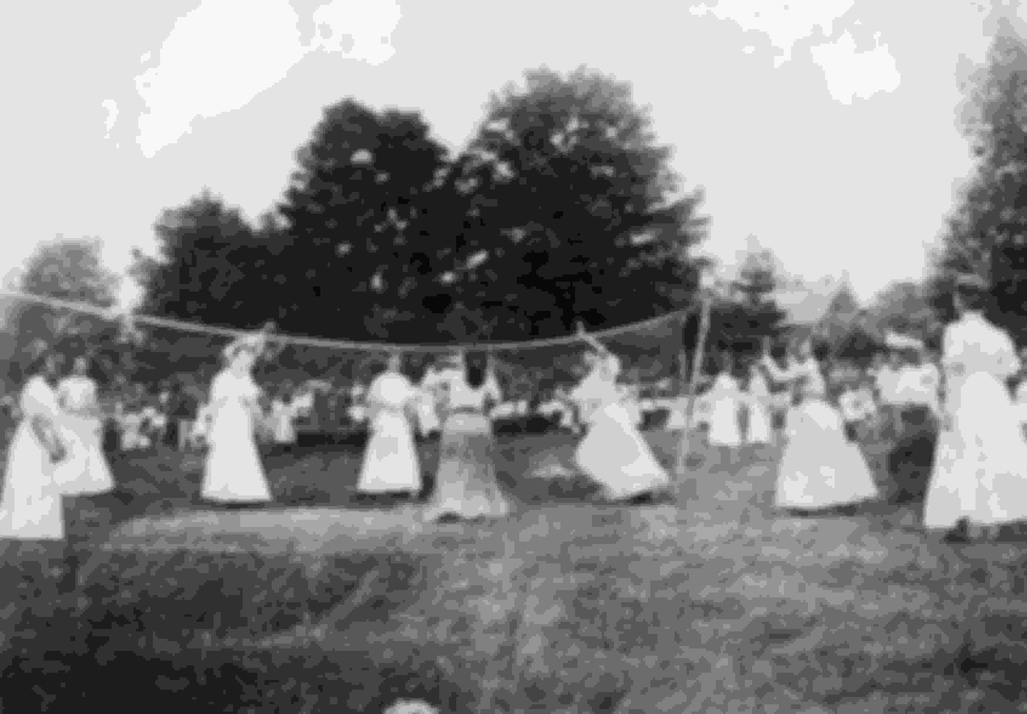 A group of ladies playing a game of volleyball in 1900.