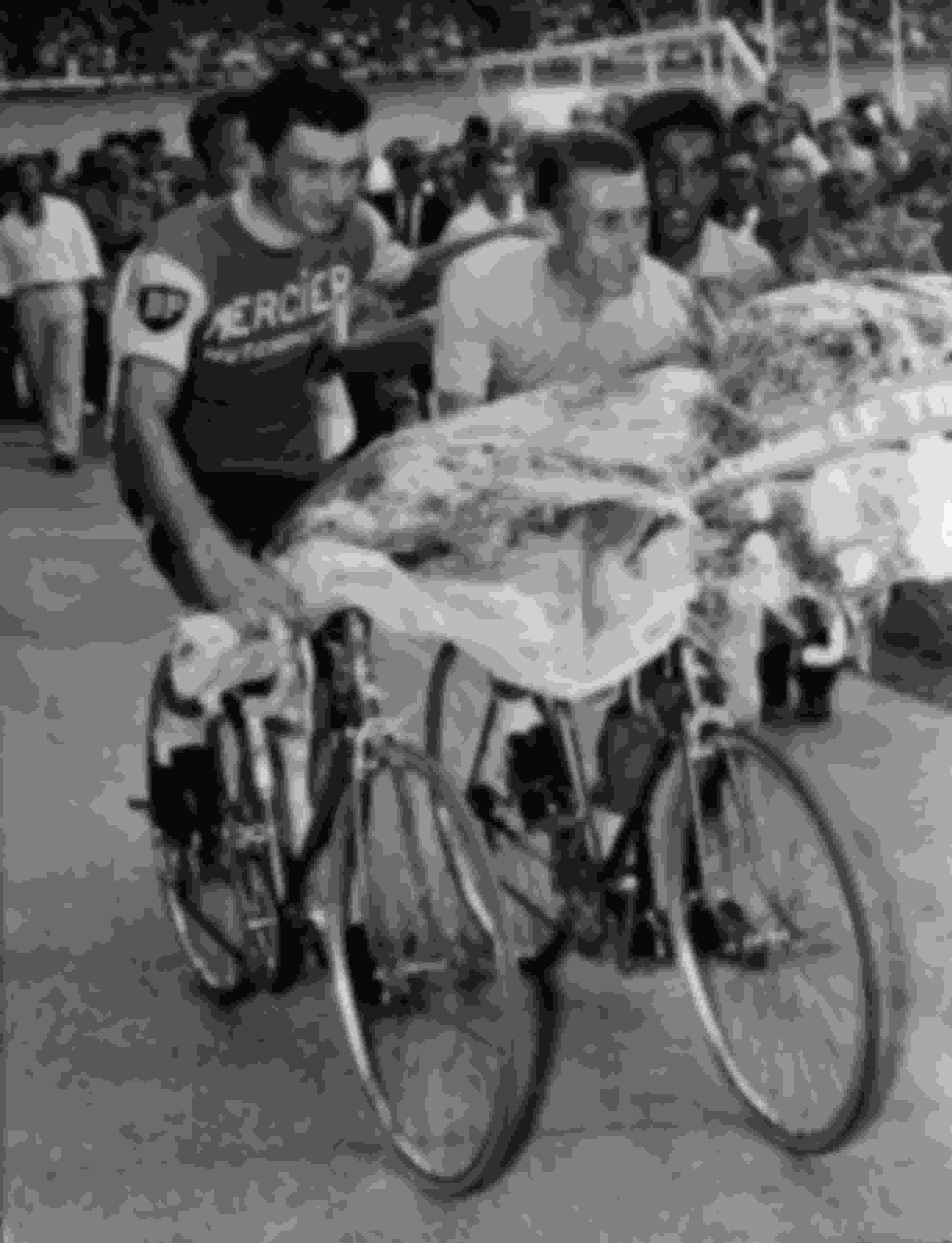 Runner-up Raymond Poulidor (L) congratulates Jacques Anquetil on his fifth consecutive Tour de France win in July 1964.