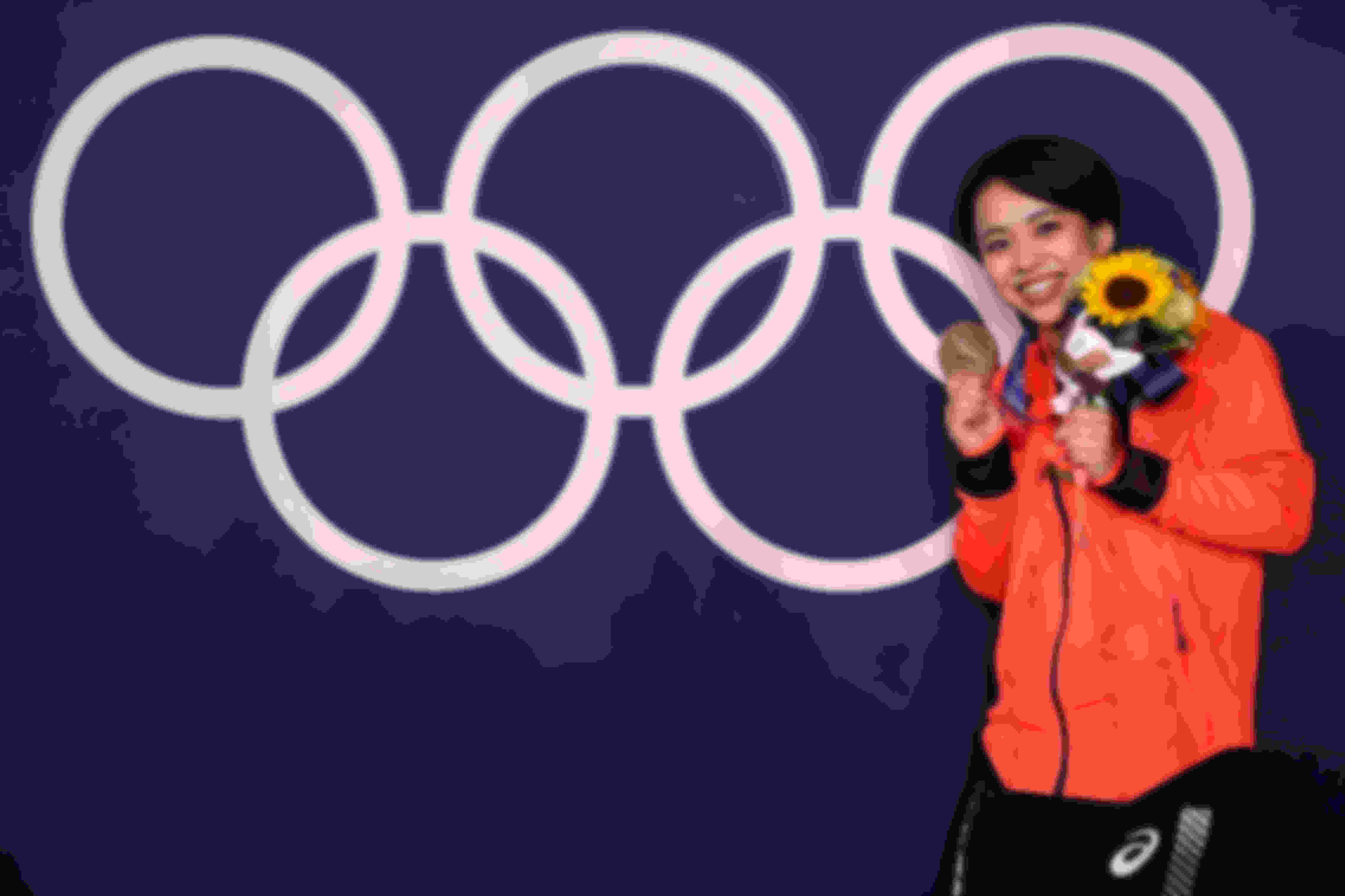 Murakami Mai posing with the bronze medal won in the women's floor event at Tokyo 2020.