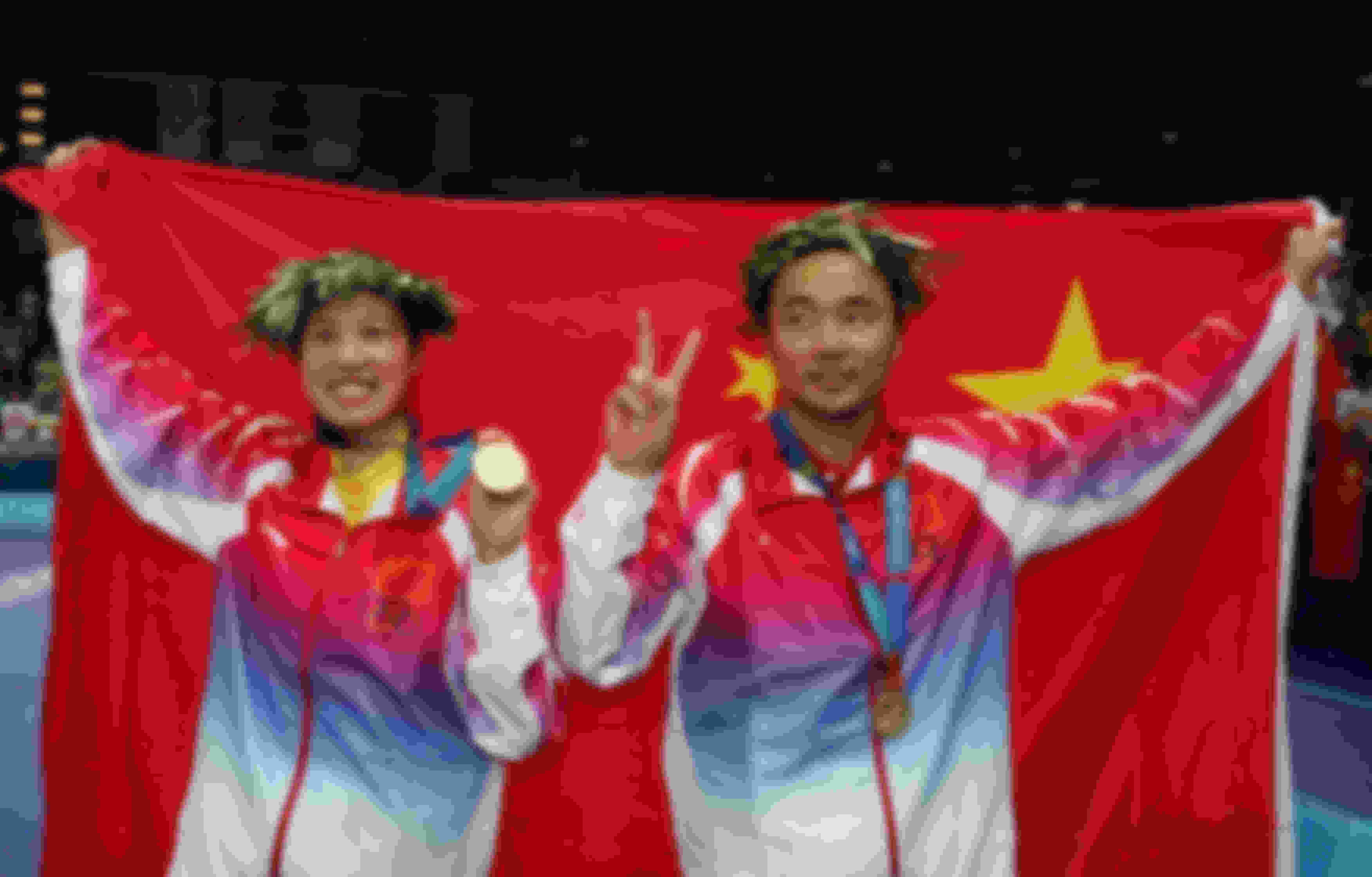 Gao Ling (left) has won a record four Olympic badminton medals.