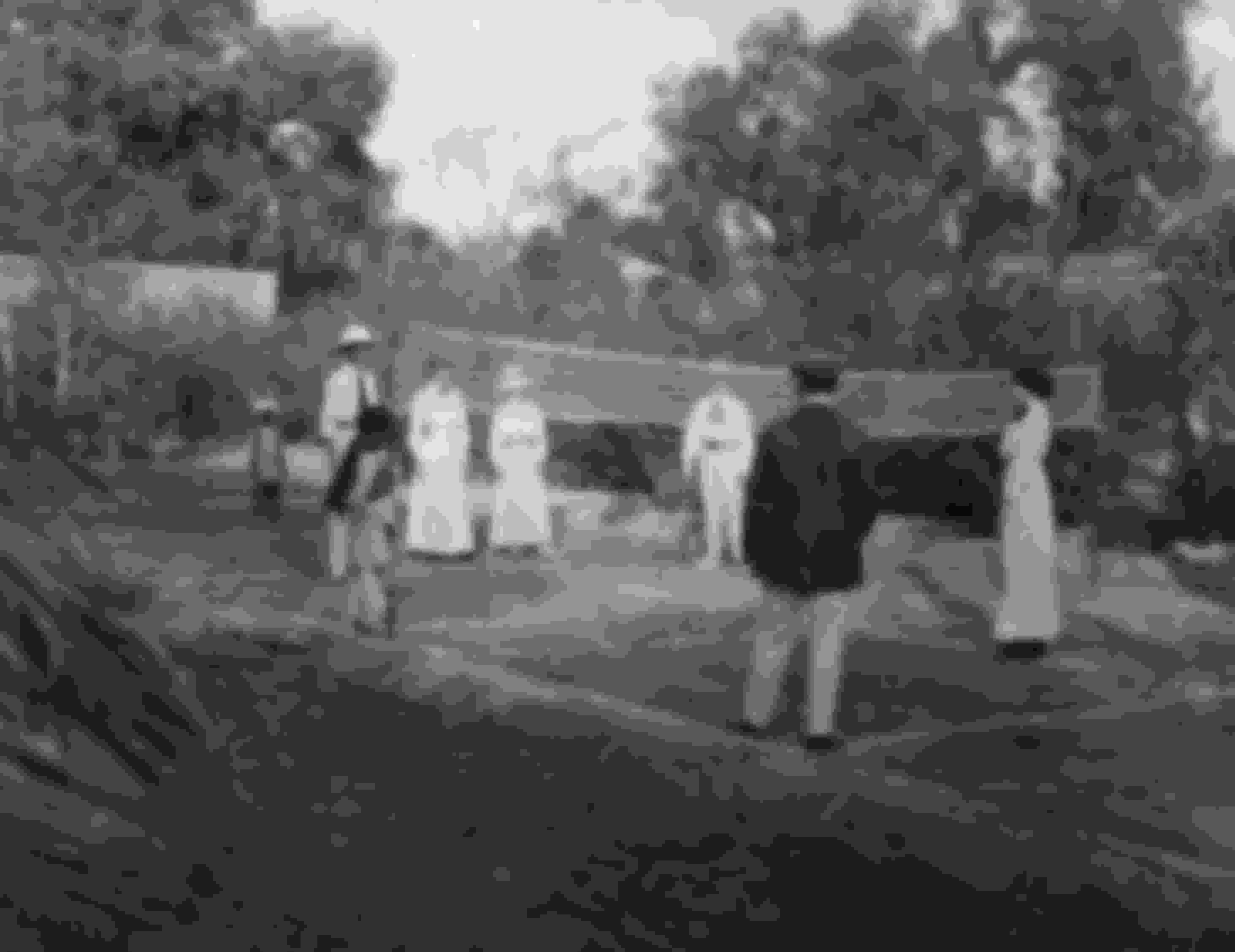 A game of badminton in progress in a garden on Monzong Road, India. circa 1912