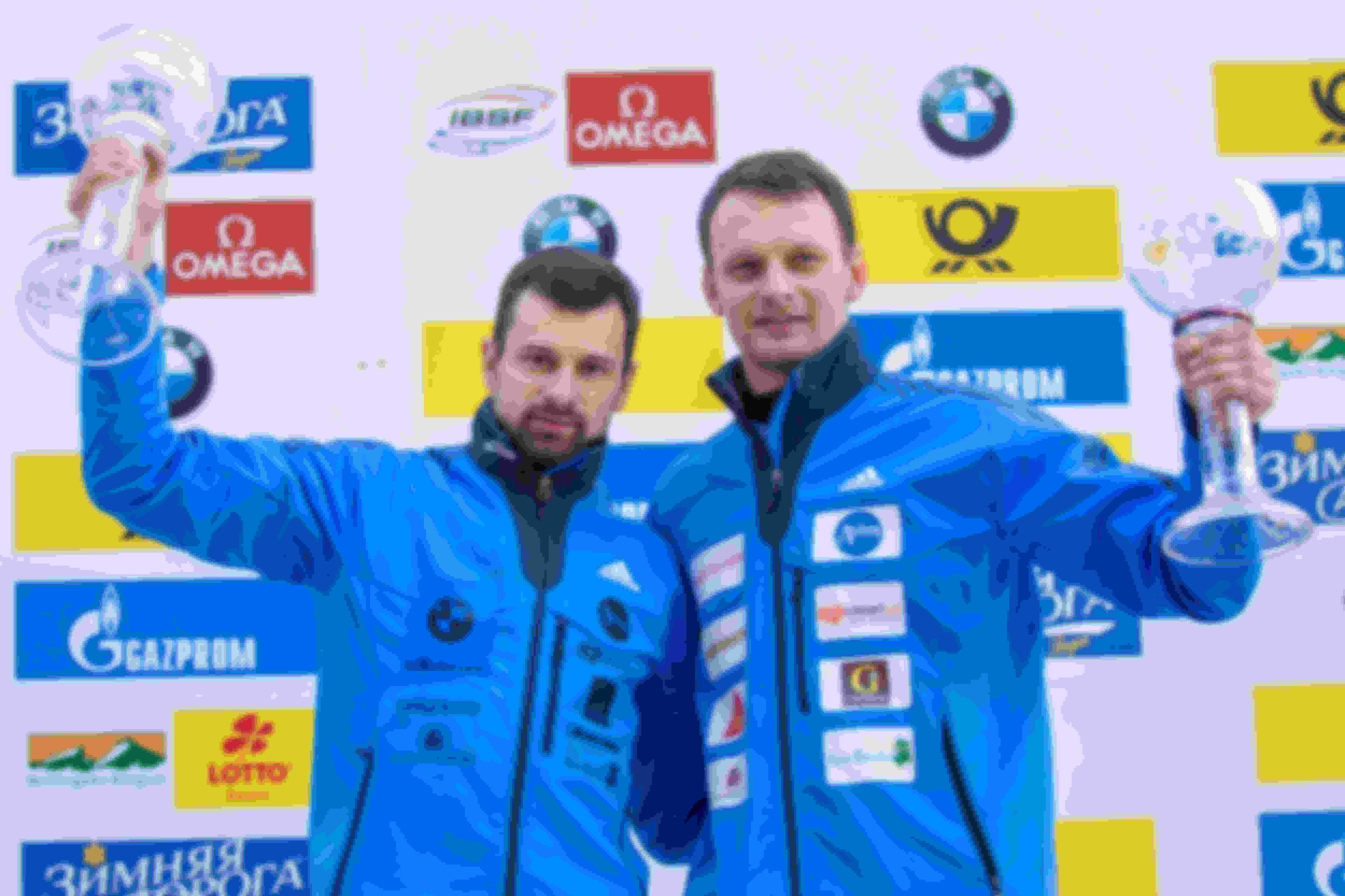 Martins Dukurs (left) and Tomass Dukurs (right) celebrate on the podium at the 2016 Skeleton World Cup in Koenigsee, Germany.