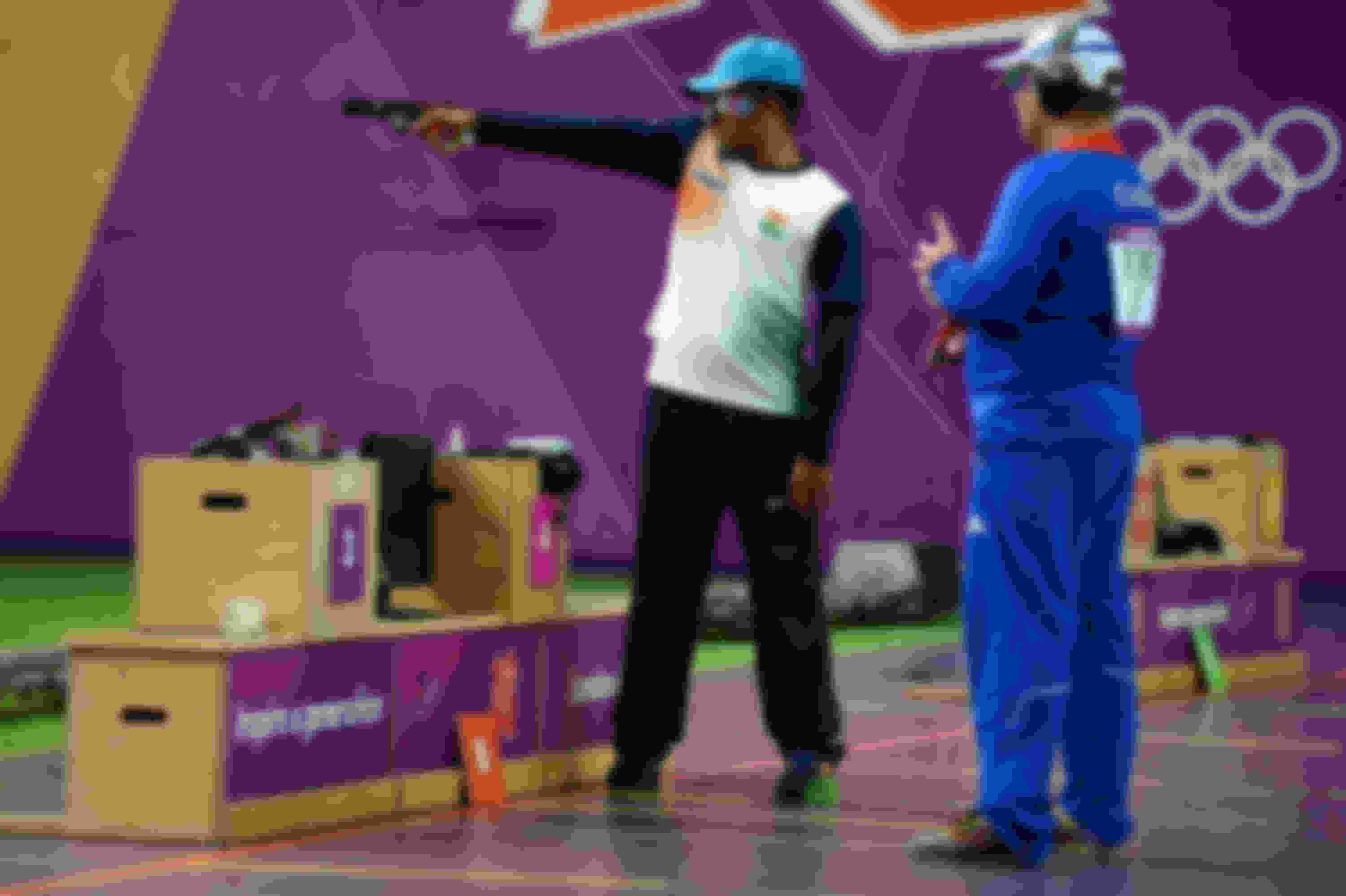 Vijay Kumar (L) of India and Leuris Pupo of Cuba compete in the men's 25m rapid fire pistol shooting final at the London 2012 Olympics.