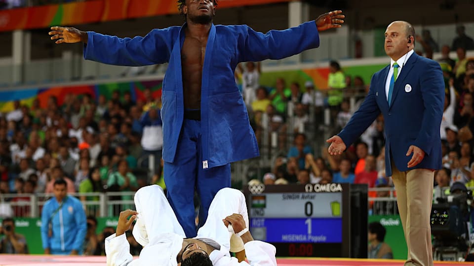 Popole Misenga of the Refugee Olympic Team celebrates after defeating Avtar Singh of India during a Men's -90kg bout on Day 5 of the Rio 2016 Olympic Games at Carioca Arena 2 on August 10, 2016 in Rio de Janeiro, Brazil. (Photo by Elsa/Getty Images)