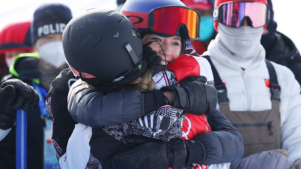  Chloe Kim of Team United States embraces Ailing Eileen Gu of Team China during the Women's Snowboard Halfpipe Final 