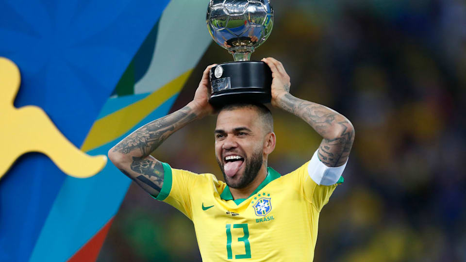 Dani Alves of Brazil celebrates with his trophy after winning the Copa America Brazil 2019 Final match between Brazil and Peru at Maracana Stadium on July 07, 2019 in Rio de Janeiro, Brazil. (Photo by Lucas Uebel/Getty Images)