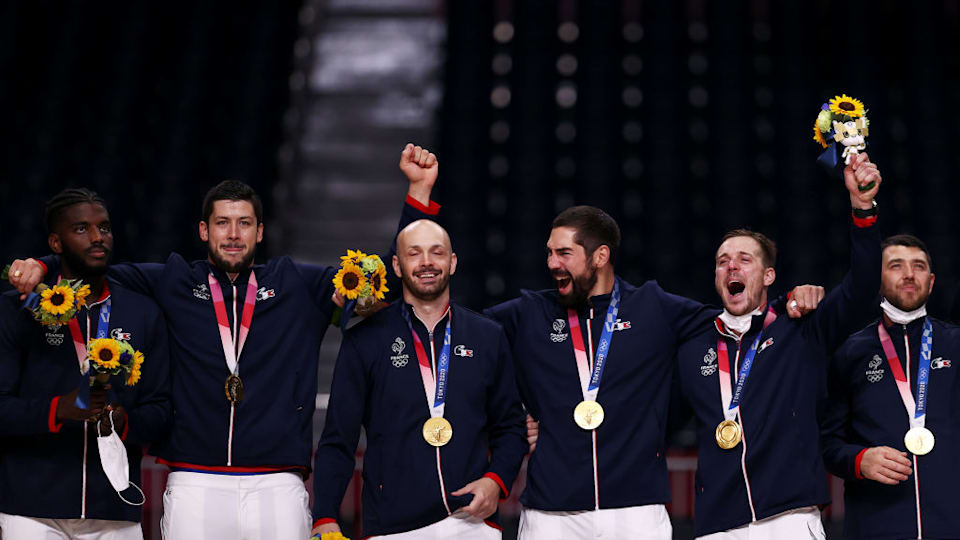 Gold medalists Team France react with their gold medals during the medal ceremony for Men's Handball on day fifteen of the Tokyo 2020 Olympic Games at Yoyogi National Stadium on August 07, 2021 in Tokyo, Japan. (Photo by Dean Mouhtaropoulos/Getty Images)
