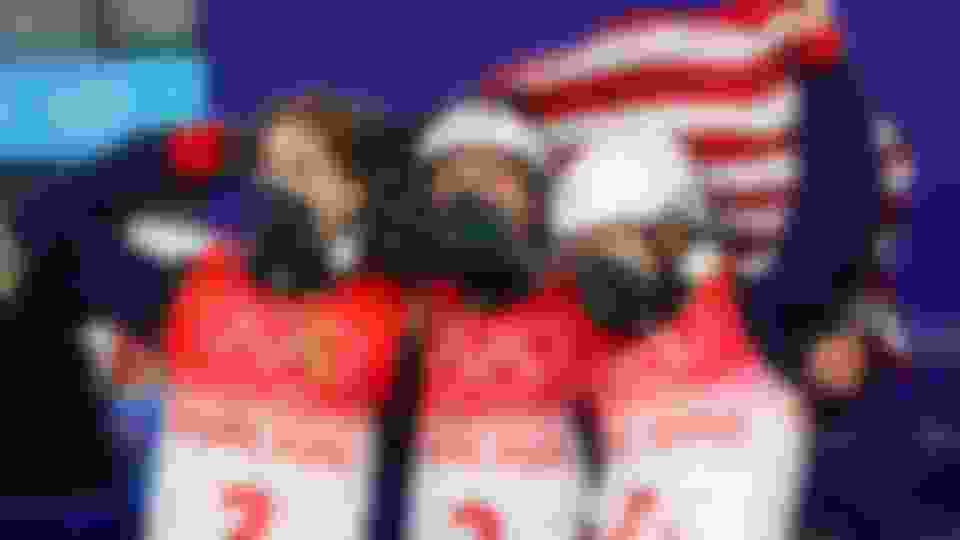 Christopher Lillis, Justin Schoenefeld and Ashley Caldwell of Team United States react after winning the gold medal during the Freestyle Skiing Mixed Team Aerials on Day 6 of the Beijing 2022 Winter Olympic Games