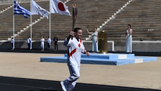 An Athlete carries the Olympic torch during the Flame Handover Ceremony for the Tokyo 2020 Summer Olympics on March 19, 2020 in Athens, Greece. The ceremony was held behind closed doors as a preventive measure against the Coronavirus outbreak. (Photo by Aris Messinis - Pool/Getty Images Europe)