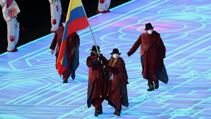 Flagbearers Laura Gomez and Carlos Andres Quintana lead out Team Colombia during the Beijing 2022 Opening Ceremony