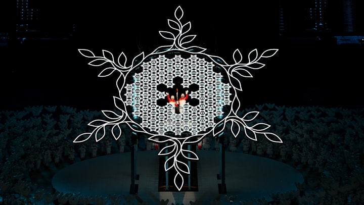 Torch bearers light the Olympic Cauldron during the Opening Ceremony of the Beijing 2022
