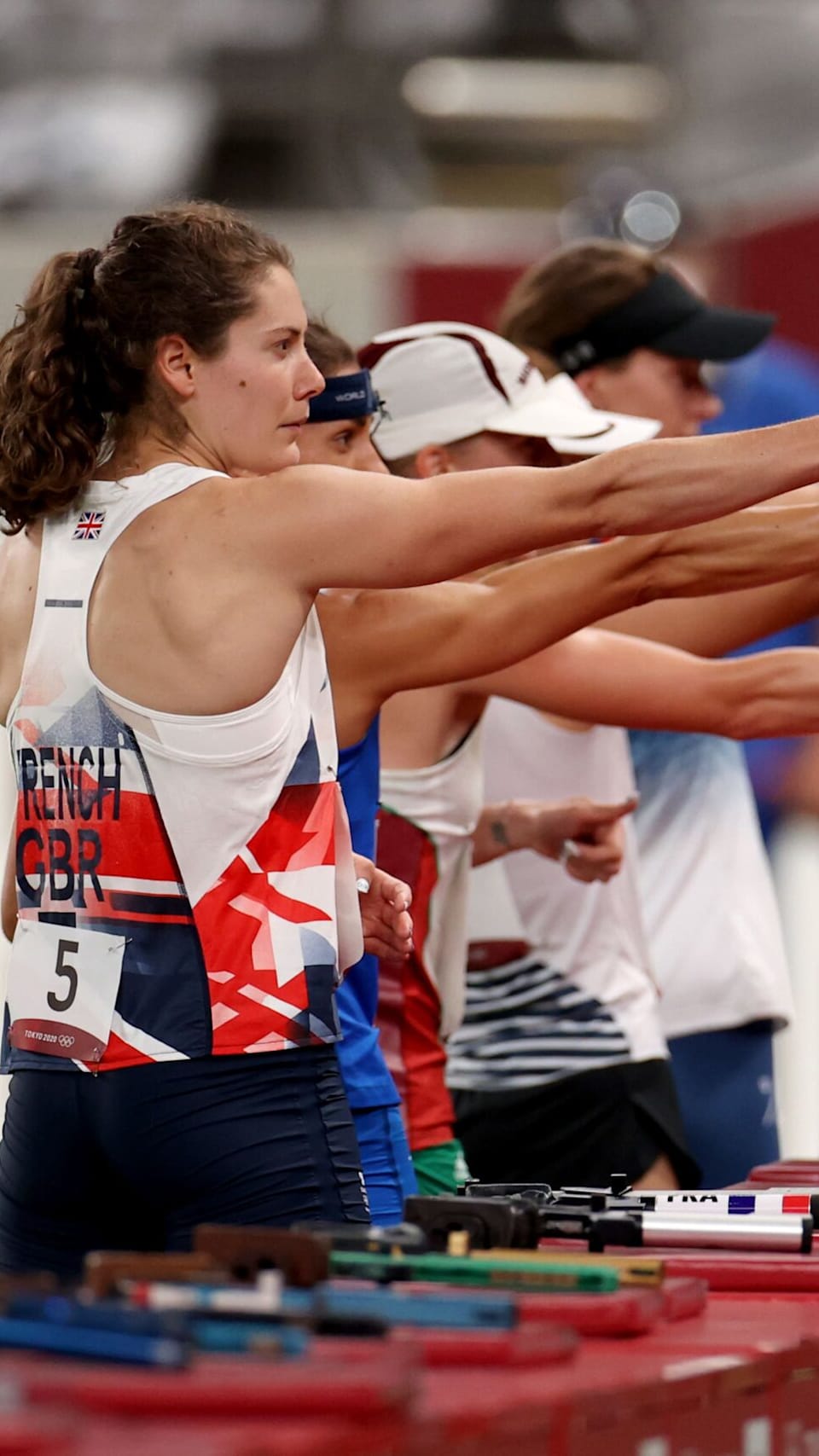 Female athlete taking position on her marks to start off the run