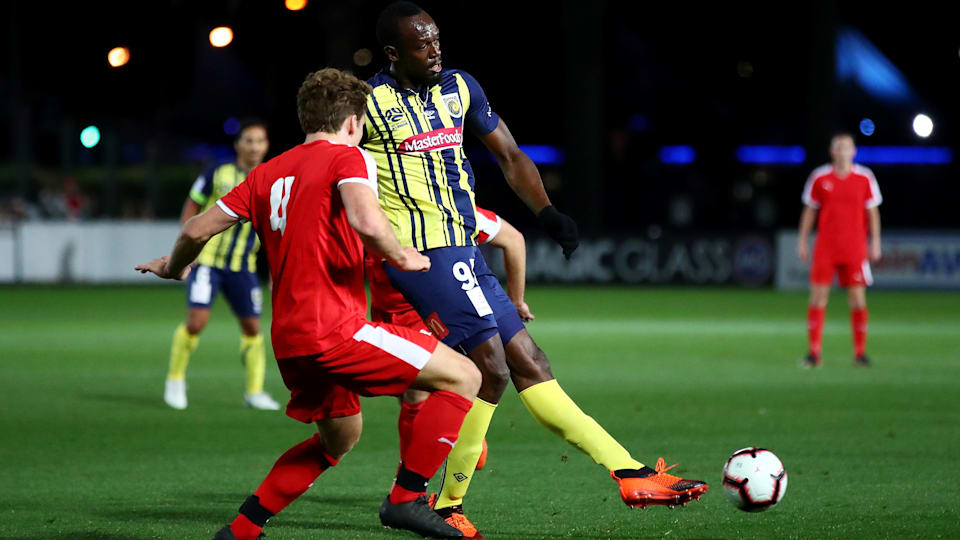 Bolt's football debut in pictures