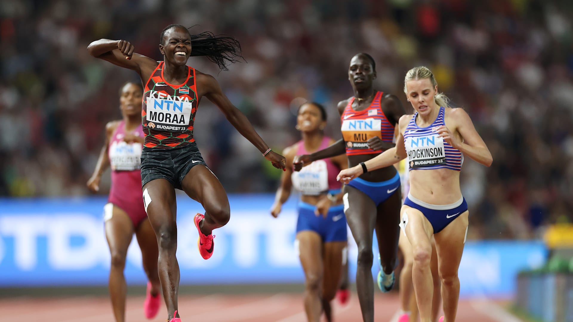 Mary Moraa jumps over the finish line to celebrate her victory in Budapest.