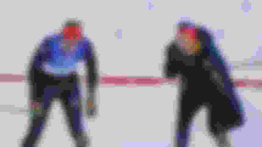 Victoria Carl crosses the finish line and Katharina Hennig celebrates in disbelief in the women's team cross-country skiing sprint in Beijing 2022.