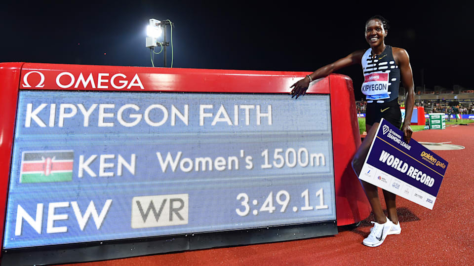 Faith Kipyegon poses next to a screen beaming her world record in the women's 1500m during the Golden Gala Pietro Mennea, on June 02, 2023 in Florence, Italy.