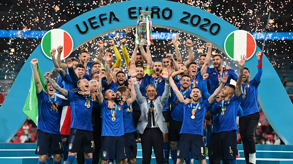  The image shows the Italian team celebrating their victory in the Euro 2020 final against England at Wembley Stadium.