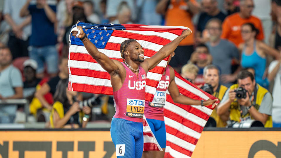 Noah Lyles celebrates with US flag - men's 200m final - 2023 World Championships
