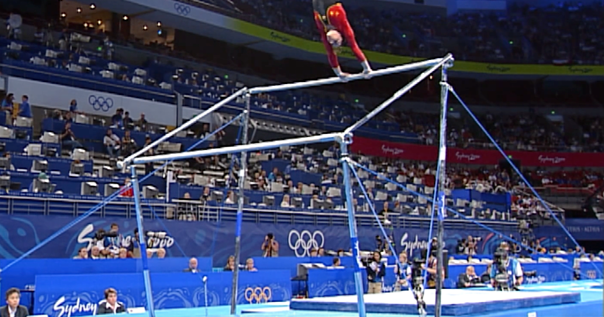 Team Spain competes on the uneven bars during qualifying at Sydney 2000